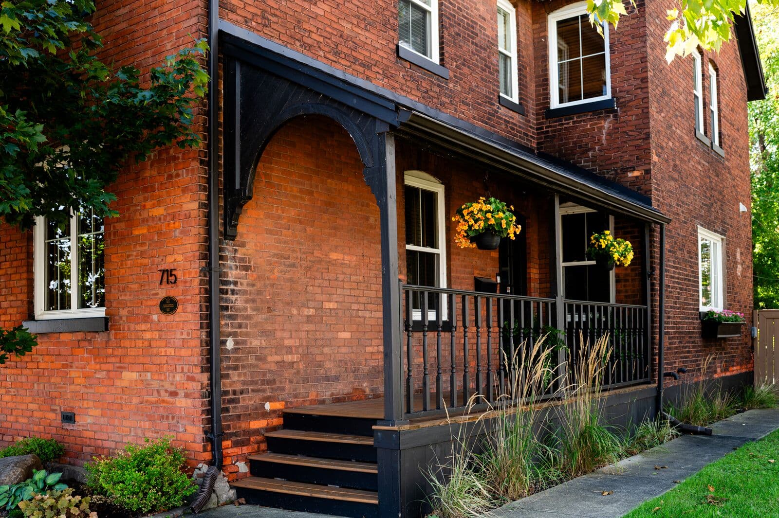 Red brick exterior and covered porch of the Walkerville Psychology house at 715 Walker Rd